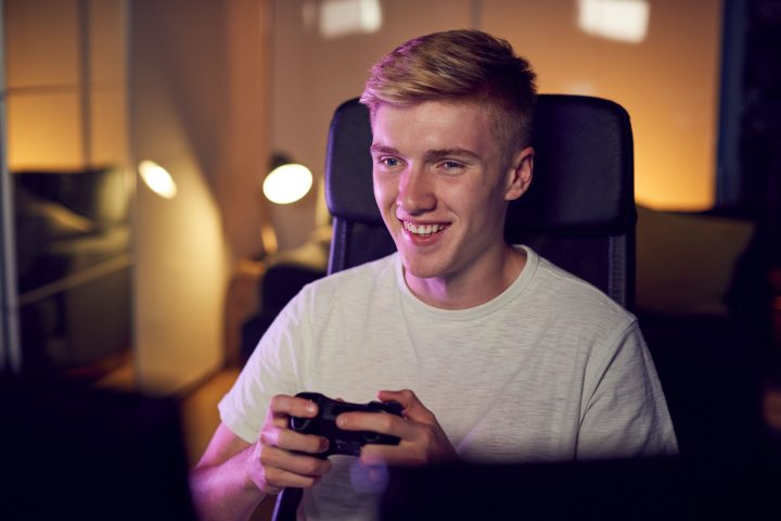 teenage-boy-with-game-pad-sitting-in-chair-and-gam-2024-10-19-10-32-46-utc.jpg