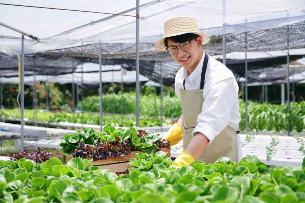 a-man-in-a-straw-hat-is-smiling-as-he-works-in-a-g-2025-01-10-03-15-04-utc-1Resized.jpg